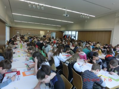 The students are sitting in our auditorium. They are 171 students from Otto Schott Gymnasium Jena in Germany and this is the largest number ever in our history. The caretakers had to bring in a whole row of new tables and chairs. Thank you for the opportunity.